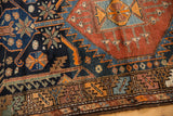 Serrated geometric patterns in navy and madder root red, with a primitive border design.