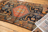 Vintage Kurdish Hamadan rug with geometric rectilinear borders and motifs in navy, madder, and orange.