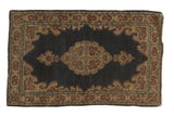Vintage Kerman rug with single Rococo medallion, indigo field, and rose borders.