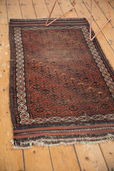 Antique Belouch rug runner with its worn, tattered fringe and geometric border.