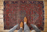 Antique Farahan Sarouk rug: delicate medallion, teal and blush palmettes on worn dusty red.