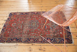 Traditional Farahan Sarouk rug with navy border, delicate floral field, and tattered fringe.