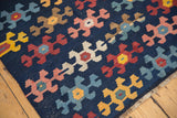 Geometric pattern details and fringe of an antique hand-woven Karabagh Kilim runner.