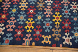 Staggered rows of playful geometric motifs on an antique Karabagh Kilim in navy, blush, and saffron.