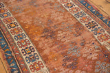 Worn geometric border, multi-paneled henna plant motifs, and frayed edge on antique Caucasian runner.