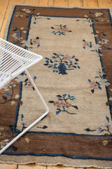 Vintage Chinese Peking runner with natural gray beige field, overlapping floral motifs, brown border.