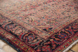 Intricate Lilihan rug corner, faded cherry red field, navy border, low pile texture.