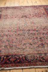 Intricate Lilihan rug border and field with dusty raspberry and navy blue patterns.