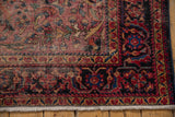 Lilihan rug corner: dusty raspberry, navy, gold floral border, showing wear and fringe.