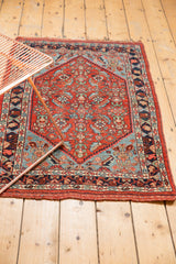 Antique Bijar rug corner showcasing a sky blue herati motif, low pile, and macrame finish.