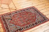 Detail of Antique Persian Bijar rug, low pile herati motif in brick red and sky blue.