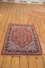 Antique Bijar rug corner with intact macrame fringe, low pile, and cherry brick red.