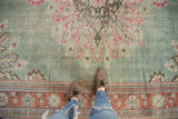 Distressed Oushak rug, mint green field, tone-on-tone shadow medallion, and raspberry red border.