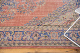 Distressed blush Oushak rug, intricate pale blue European scrolling motifs and border.