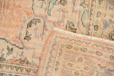 Distressed vintage Oushak carpet with soft palette, pile wear, fringe, and woven foundation.