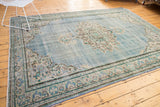 Vintage distressed Oushak border, European-influenced design in faded blue, mint, and ivory.