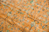 Distressed apricot orange Oushak rug detail, scrolling vinery, ivory, mint, and worn pile.