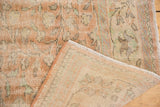 Distressed Oushak carpet showing worn pile, faded vinery, and reverse woven foundation.