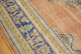 Textured distressed apricot blush field with faint foundation, bordered by faded royal blue motifs.