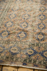 Worn pile of a distressed Oushak rug, with apricot and pale navy mini medallions.
