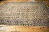 Distressed vintage Oushak rug, worn low pile showing foundation, apricot and navy medallions.