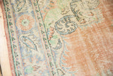 Distressed vintage Oushak pile texture featuring blush, ivory, mint, and pale blue.