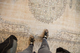 Distressed Sparta carpet, ivory field with worn knot heads, faded dusty green blue patterns.