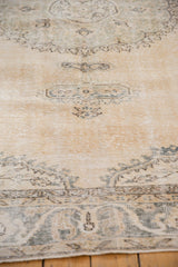 Distressed vintage Sparta carpet with even wear, exposed foundation, ivory and dusty green-blue tones.