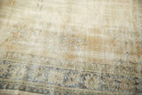 Distressed vintage Oushak rug showing worn texture, knot heads, and faded border.