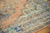 Vintage distressed Oushak carpet texture with apricot, sea foam, and blue rococo florals.