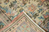Distressed vintage Oushak rug corner with worn pile, red binding, and European style motifs.