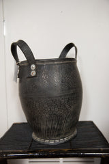 Recycled rubber basket planter base, highlighting textured surface and white stitching.