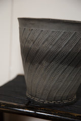Recycled rubber basket with textured diagonal ribs and stitched bottom edge.