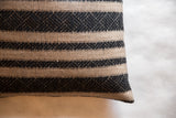 Textured onyx black geometric stripe pattern on a natural reclaimed pillow.