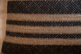 Reclaimed pillow with onyx black geometric striped pattern on natural fabric.