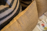 Reclaimed jute pillow's fine black dash pattern with contrasting faux suede edge.
