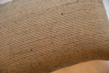 Black and jute reclaimed remnant pillow showing distinct woven pattern.