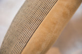 Black and jute perforated fabric meeting soft tan faux suede on pillow.