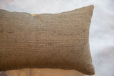 Reclaimed remnant black and jute pillow's textured fabric pattern.