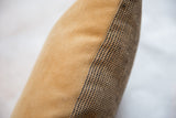 Textured tan faux suede and black and jute dot pattern on pillow.