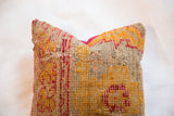 Woven texture and vibrant orange and red pattern of the antique Turkish rug fragment pillow.
