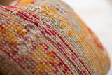 Crimson, gold, and tan weave texture of the antique Turkish rug fragment pillow.