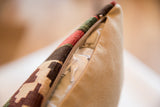 Zippered side of reclaimed kilim fragment pillow, revealing recycled insert and geometric pattern.
