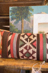 Flatweave geometric pattern in earth tones on a reclaimed antique Kilim fragment lumbar pillow.