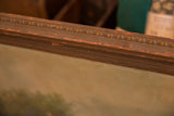 Antique painting frame detail with decorative molding, chipped brown paint, and orange patina.