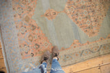 Softened terra cotta Herati motifs with abrashes on the distressed blue Malayer carpet.