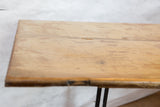 Faded sage cream paint on the textured reclaimed wooden end table top.