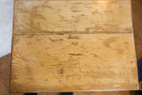 Close-up of the reclaimed wooden tabletop with faded sage cream paint texture.