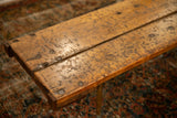 Reclaimed wooden tabletop showing distressed texture, nail heads, and warm natural grain.