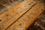 Reclaimed wood table's textured surface with natural wear and central split.